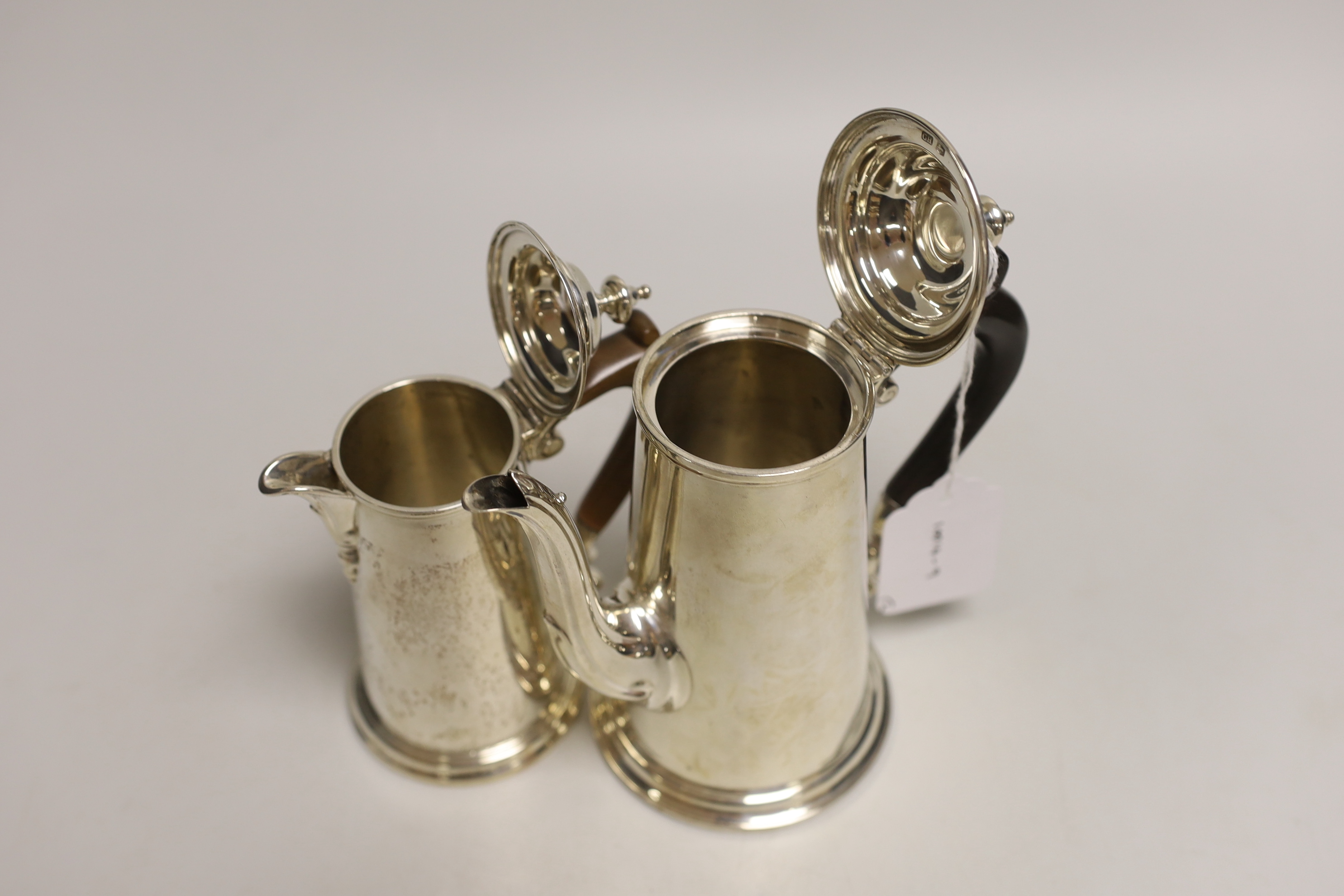 Two George V silver cafe au lait pots, the smaller by Chares & Richard Comyns, London, 1926, gross weight, 18.2oz.